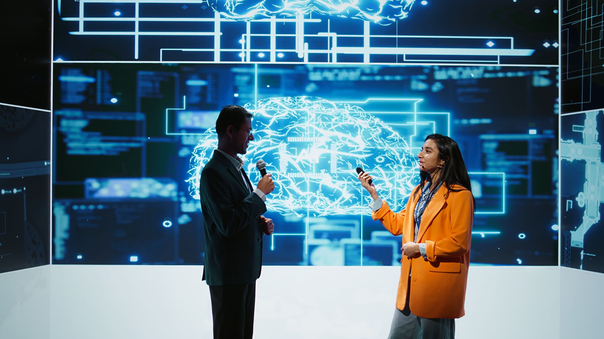 Presenter and guest chatting during AI summit discussion panel